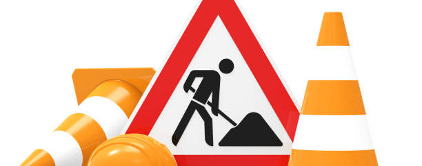 Under construction, road sign, traffic cones and safety helmet, isolated on white background 3D rendering
